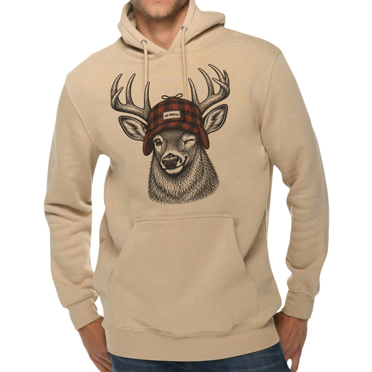 A man wearing a beige pullover hoodie with a graphic print of a deer head wearing a red plaid hat. The hoodie has a front kangaroo pocket and drawstrings, shown against a plain white background.