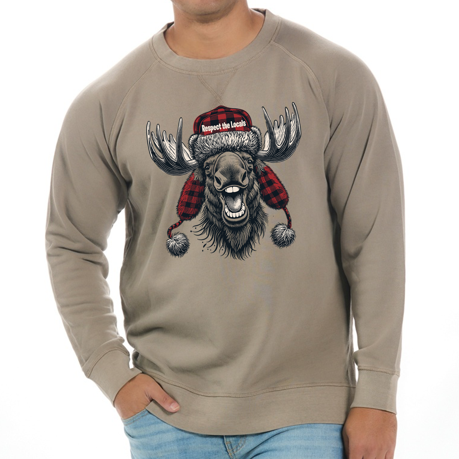 Tan raglan sweatshirt featuring a bold graphic of a grinning moose wearing a red and black buffalo plaid trapper hat with the text "Respect the Locals."